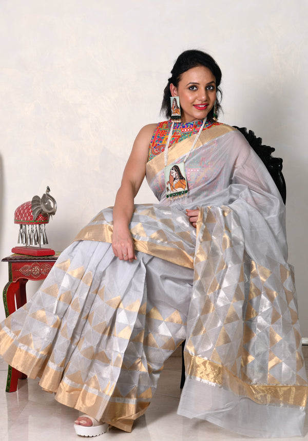 A one of a kind grey geometry Chanderi Saree that has a Monotonous grey colour enchanted with geometry of triangles, gold and silver spread over the bottom and the pallu 
