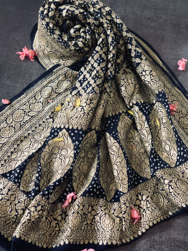 Enrich Your Wardrobe With Dark Blue Georgette Bandhini dupatta, rich neem zari woven on pure georgette is lite and royal at the same time Dupatta is a pure georgette banarsi machine made fabric with hand tie dyed bandhej knots in white shop now at chowdhrain